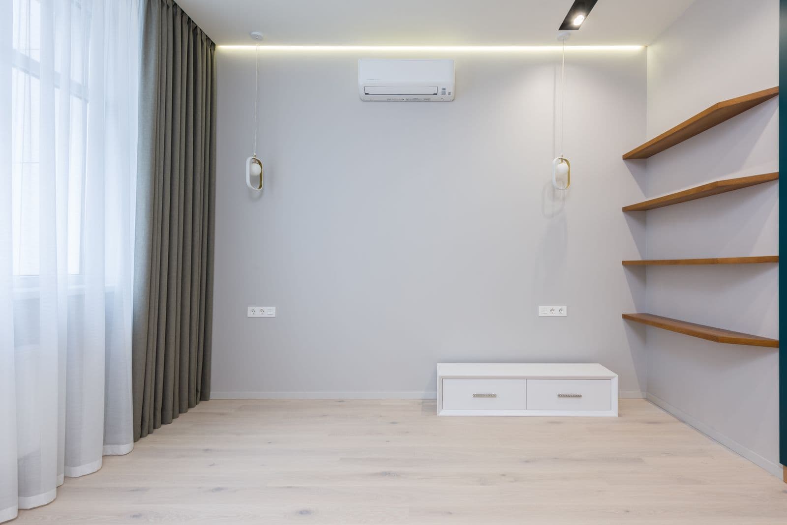 Wall-mounted ductless mini-split air conditioner head installed inside a modern home