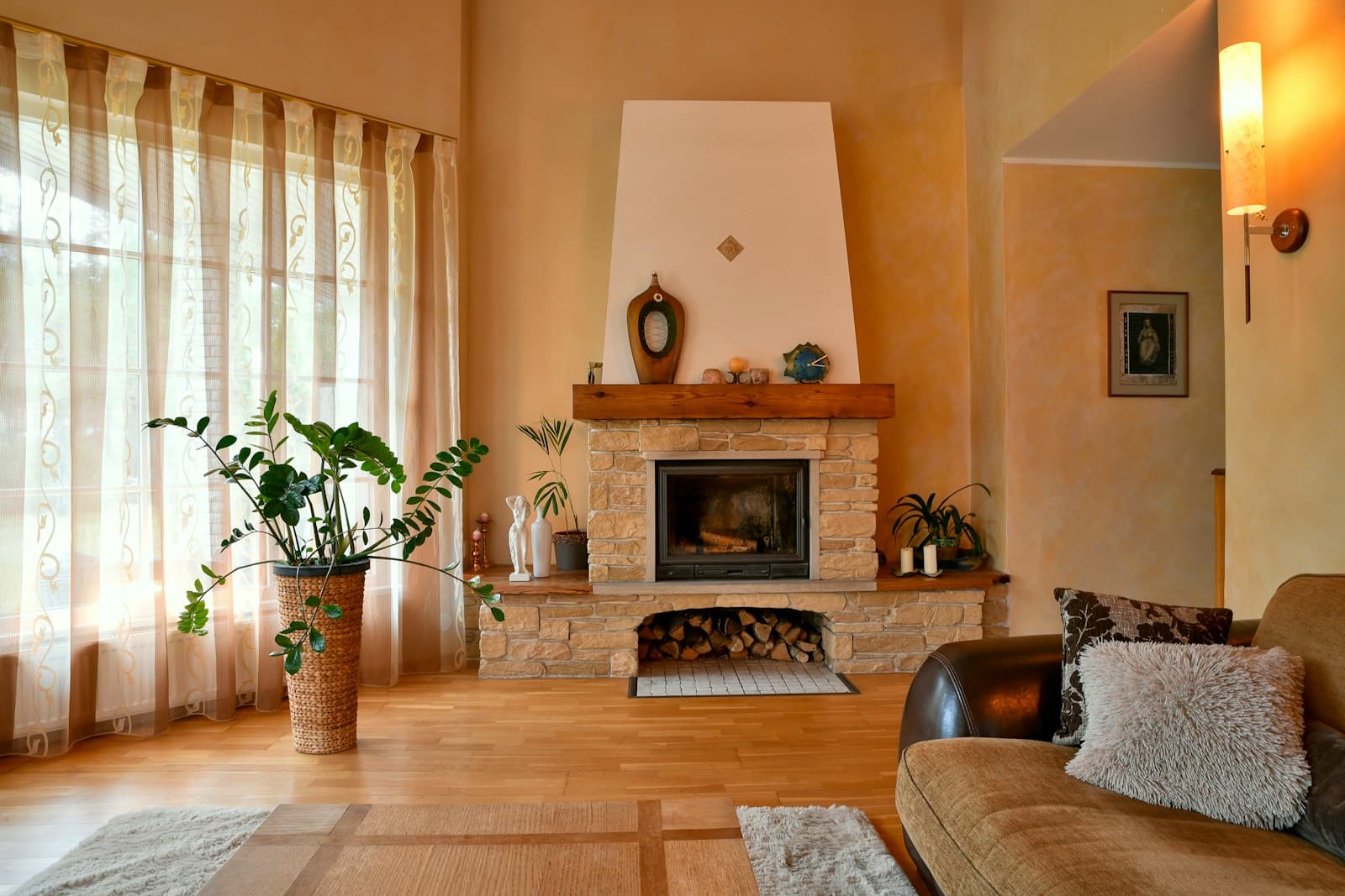 Warm cozy living room interior with a stone fireplace and hardwood floors during the winter months